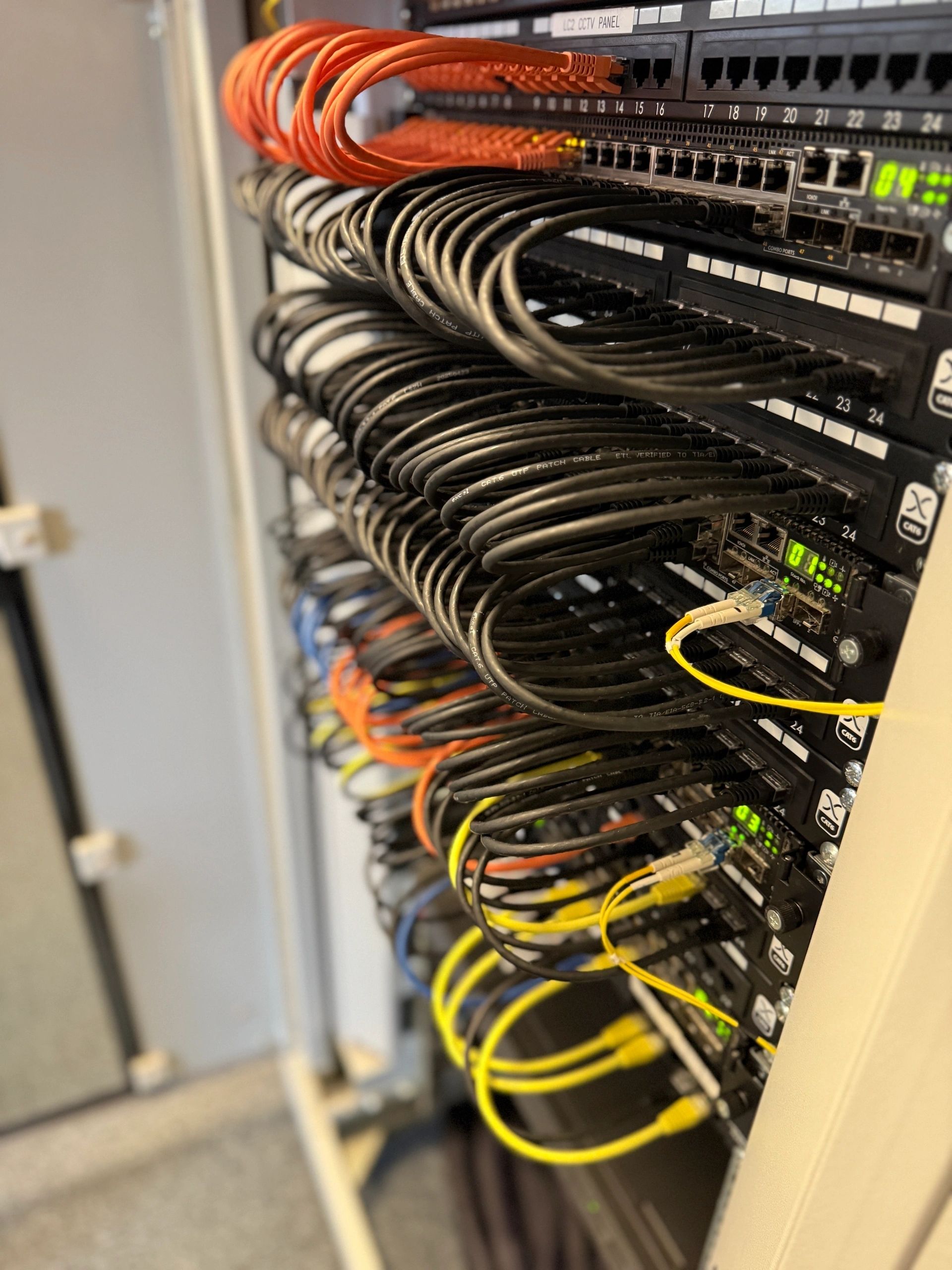 Ethernet cables connected to switch ports with LED lights