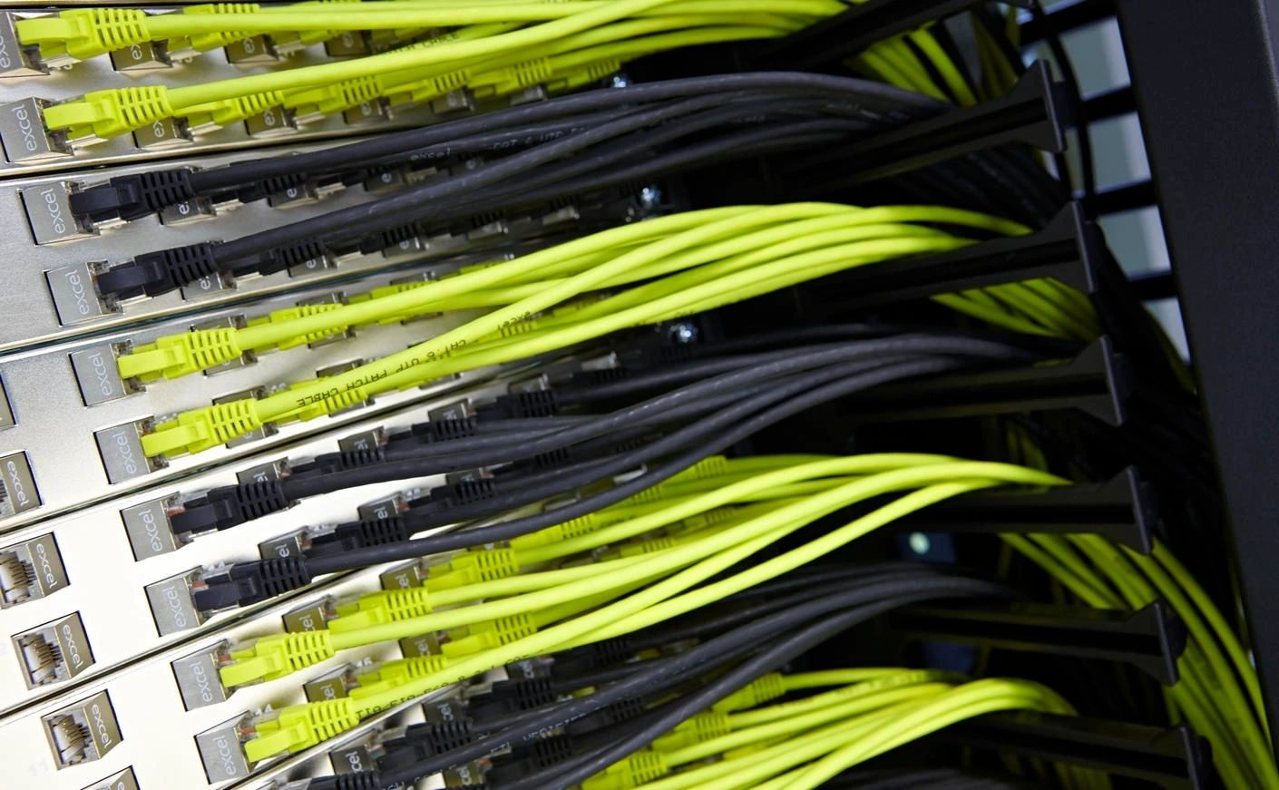 Neon yellow network cables in a server rack